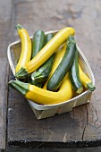 Punnet of yellow and green courgettes