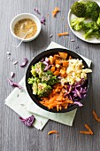 Broccoli, red and white cabbage, carrot and sweet potato Buddha bowl