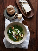 Italian wedding soup with bread dumplings and parmesan