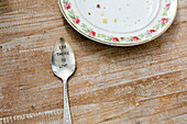 Leftover cake on a plate and a message of love on a spoon