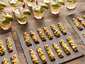 Toasted bread with avocado and smoked salmon, cocktail with lime and chilli