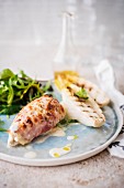 Chicken fillet grilled with bacon and grilled chicory