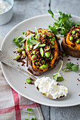 Sweet potatoes stuffed with quinoa, broad beans, fromage frais