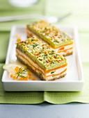 Mille-feuille from smoked salmon, pesto, fromage frais, spring vegetable and white bread