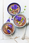 Chocolate mousse with almonds, hazelnuts, pansies and mint