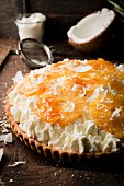 Topping the whipped cream with the roasted pineapple rings and grated coconut