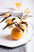 Fried anchovy and citrus fruit brochettes