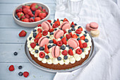 Berry cake with cream and macarons