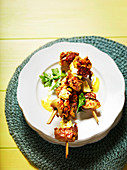 Marinated Indian chicken skewers with green olives and cheese
