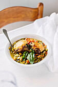 Minestrone with artichokes, beans, cheese and basil