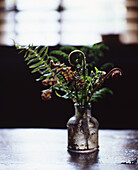 Fern branches in an old bottle