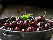 Metal sieve with fresh cherries