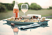 Platter of seafood and bottle of wine on an outdoor table