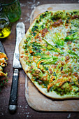Pizza with pesto and zucchini flowers