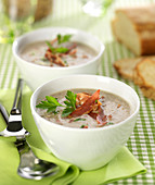 Creamed mushroom soup with thin strips of crispy bacon