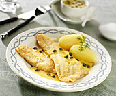 Whiting fillets in lemon sauce with capers, boiled potatoes