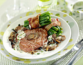 Veal Grenadin with mushrooms, broad bean bundles tied with bacon