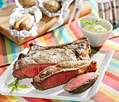 Beef chop with Béarnaise sauce and baked potatoes