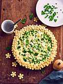 Feta, pea and mint pie decorated with pastry flowers