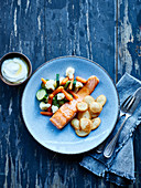 Grilled salmon, salted potatoes and pan-fried vegetables