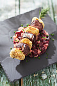 Skewer of breaded snails and duck breast, beet and apple remoulade