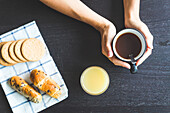 Women's hands holding a cup of coffee