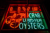 Neon advert for a fish shop