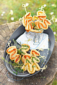 Three colored pesto zigzag puff pastry appetizers outdoors