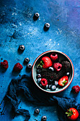 Still life of red fruits on blue background