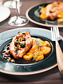 Guinea-fowl fillet garnished with dried fruit and stewed apricots
