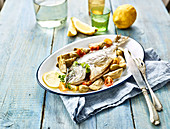 Sea bream baked in the oven with green olives and cherry tomatoes