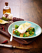 Piece of cod with lemon zests,broccolis and potatoes