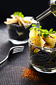 Tintenfischspaghetti und Kräuter-Farfalle mit Öl beträufeln