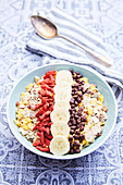 Muesli with goji berries, banana and chocolate