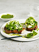 Crostinis with green tomatoes, burrata, herbs and green sauce