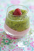Glass of raspberry mousse with kiwi coulis