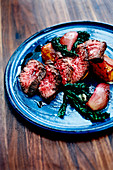 Grilled rump steak with shallots,confit sweet potatoes and Swiss chard greens