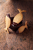 Easter fish-shaped shortbread biscuits with chocolate sauce dip