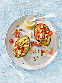 Grilled avocado with cherry tomatoes,Mahon cheese and pistachios
