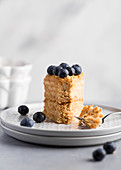 Piece of honey cake with blueberries