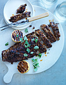 Pork ribs glazed with honey and grilled lemons