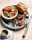 Roasted rack of lamb with bell pepper fregula, capers and anchovies