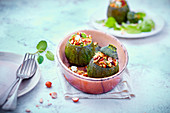 Courgettes stuffed with quinoa, raisins, feta and goat's cheese