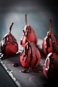 Pears poached in red wine with chocolate sauce