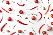 Chilli, tomatoes, garlic and thyme on white background