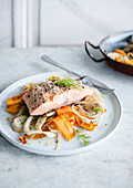 Salmon with sesame seeds on carrot-fennel vegetables