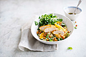 Chicken breast on bulgur with oranges and chickpeas