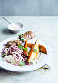 Lamb skewer with sweet potatoes and salad