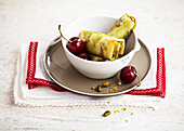 Brick pastry pockets with cherries and pistachios