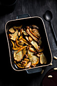 Autumn oven vegetables with parsnips, pumpkin, garlic, onions and roasted almonds